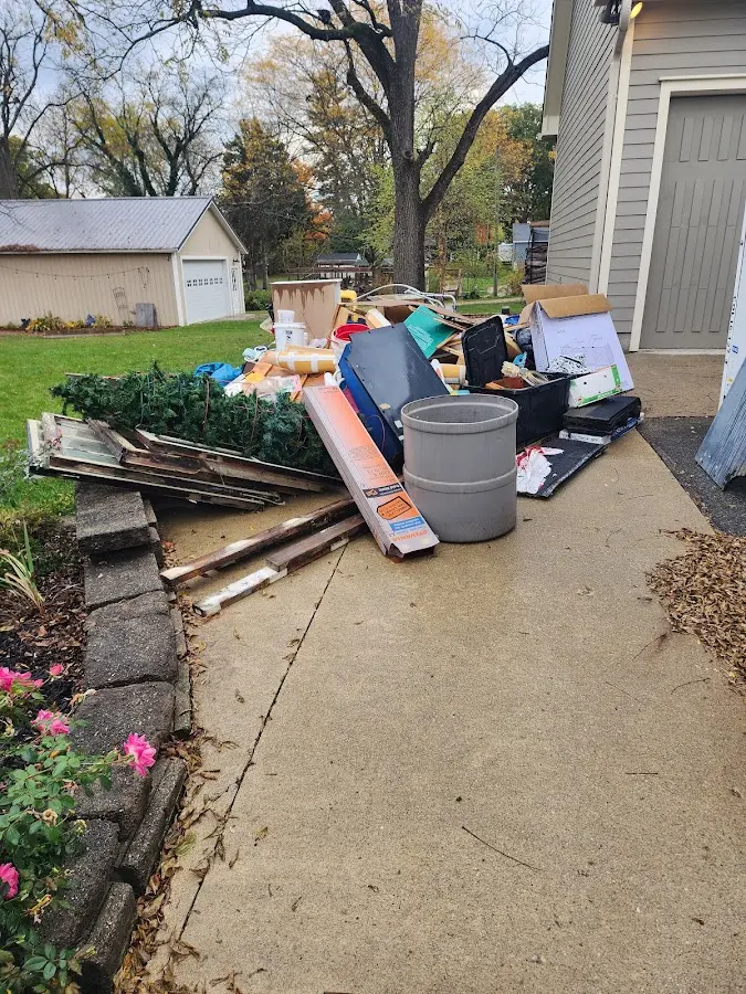 Dumpster being loaded with debris for Roofing Dumpster Rental in Manchester